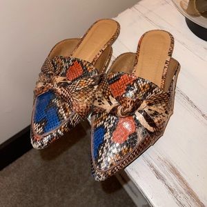 Multi color, snake skin flat mules. Woman’s size 5.5.